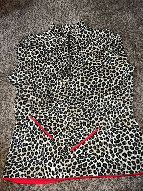 3/4 zip leopard print athletic pullover with red trim detail.